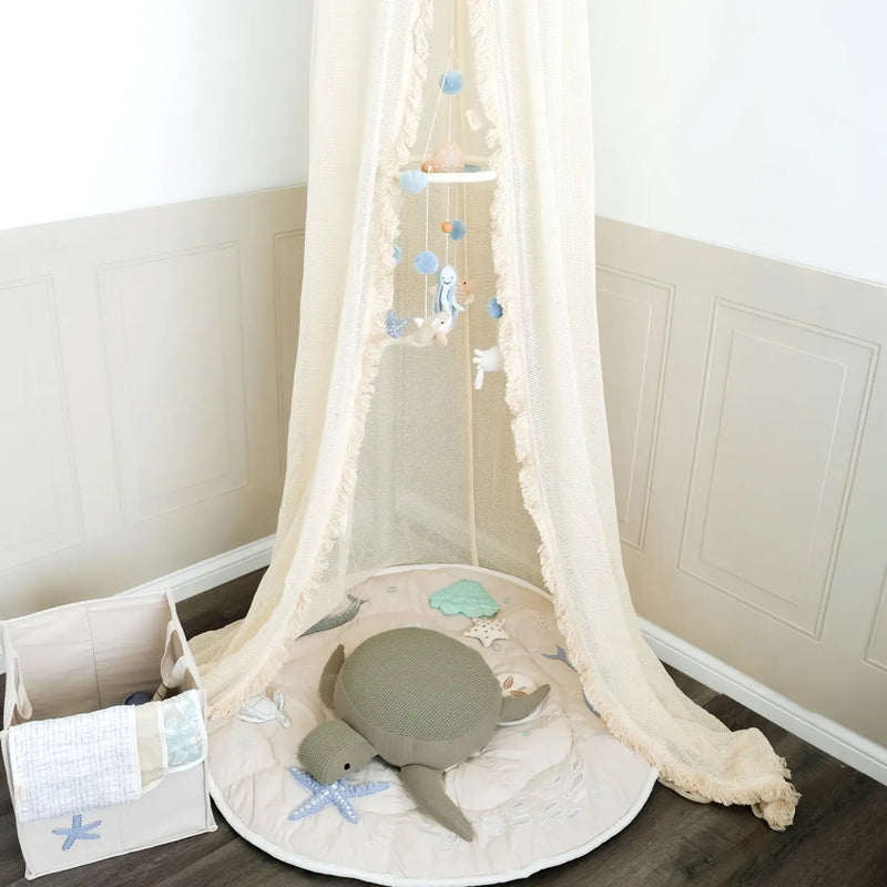 ocean themed crane baby nursery including green knitted cotton stuffed turtle toy 