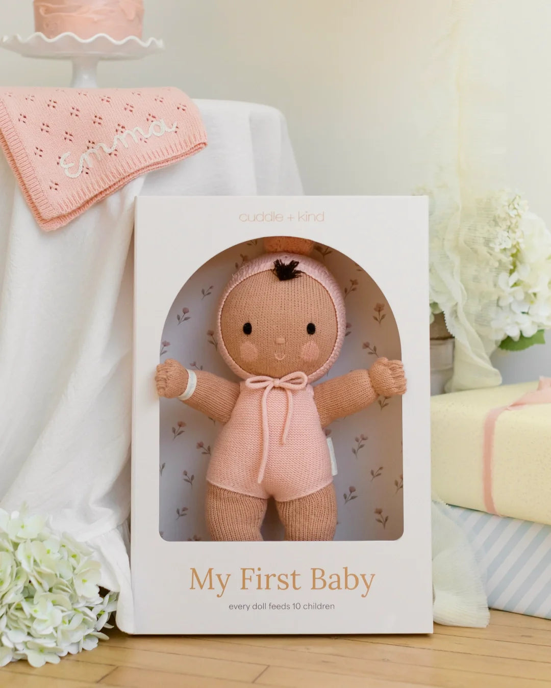 Peach My First Baby from Cuddle + Kind, a hand-knit cotton doll that gives 10 meals to kids in need