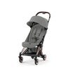 RoseGold + Sepia Black Cybex Coya, a versatile stroller for traveling with your baby.