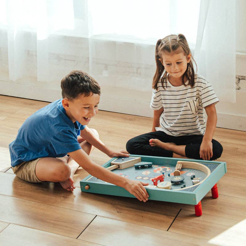 Wonder and Wise Blast Off Pinball tabletop pinball machine with adjustable feet on flat surface for ages 3 and up