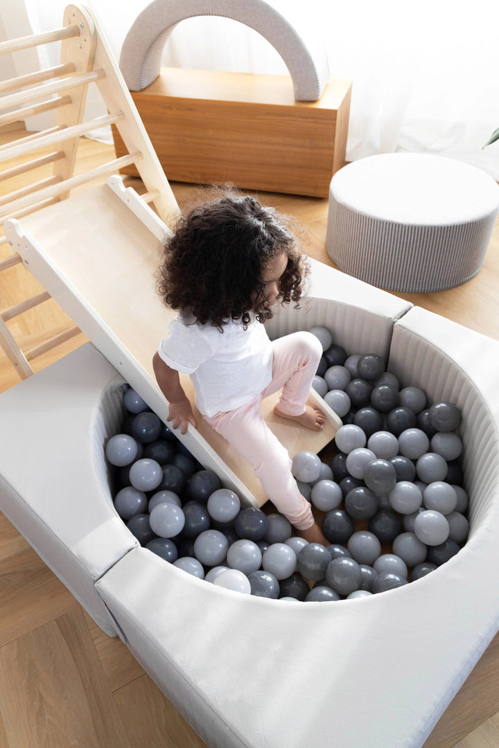 Encourage active movement with the Coco Village Montessori 2-in-1 Grip Climber Board & Slide in Natural, a smart developmental toy for growing kids.