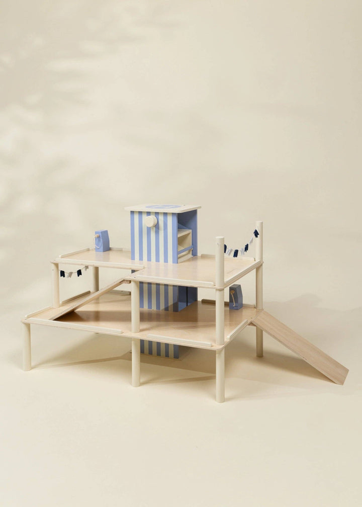 Angled view of the Wooden Parking Garage Playset by Coco Village with connecting ramps