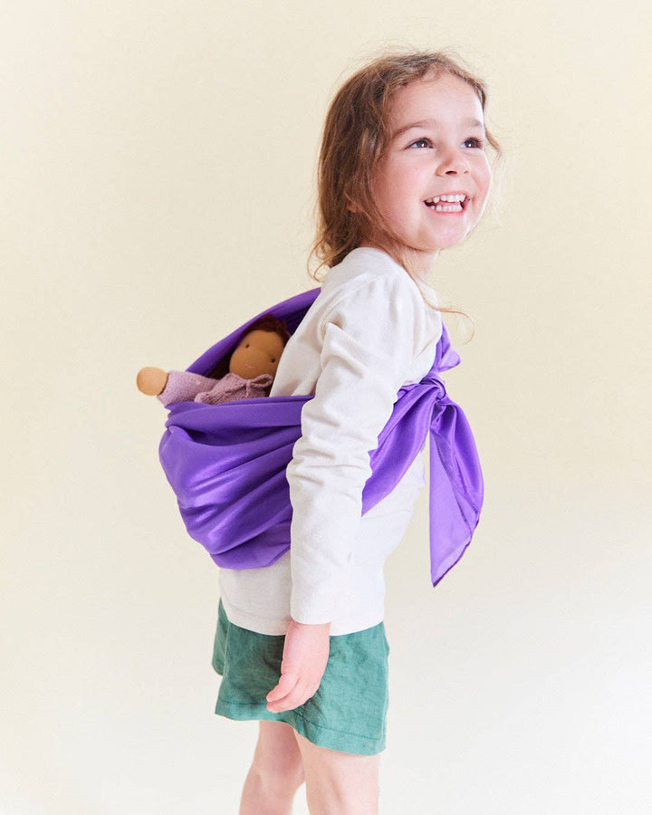A top rated kids toy, this purple Sarah's Silks Solid Color Playsilk doubles as a sling carrier