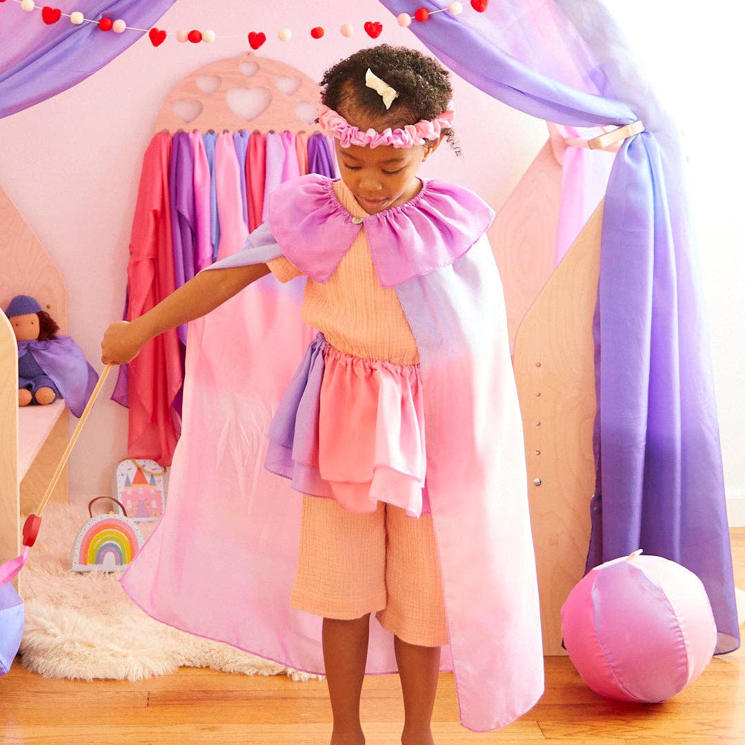 Dressed in flowing silk, a child wears the Sarah's Silks Blossom Garland while playing pretend