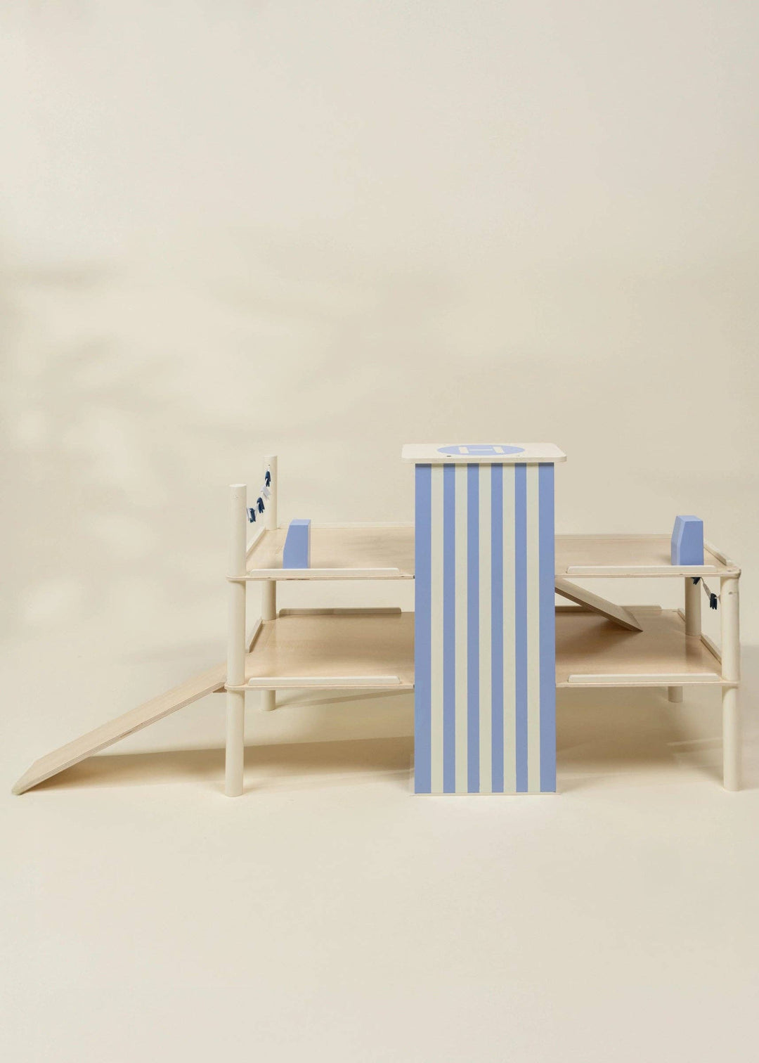 Close up of the striped elevator column on Coco Village's wooden parking garage toy