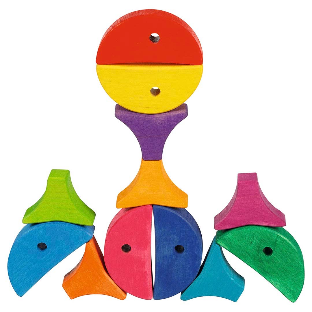 Toddlers explore shapes and colors with the Goki Colour and Shape Sorting Game - 6 colourful fishes, a kids toy.