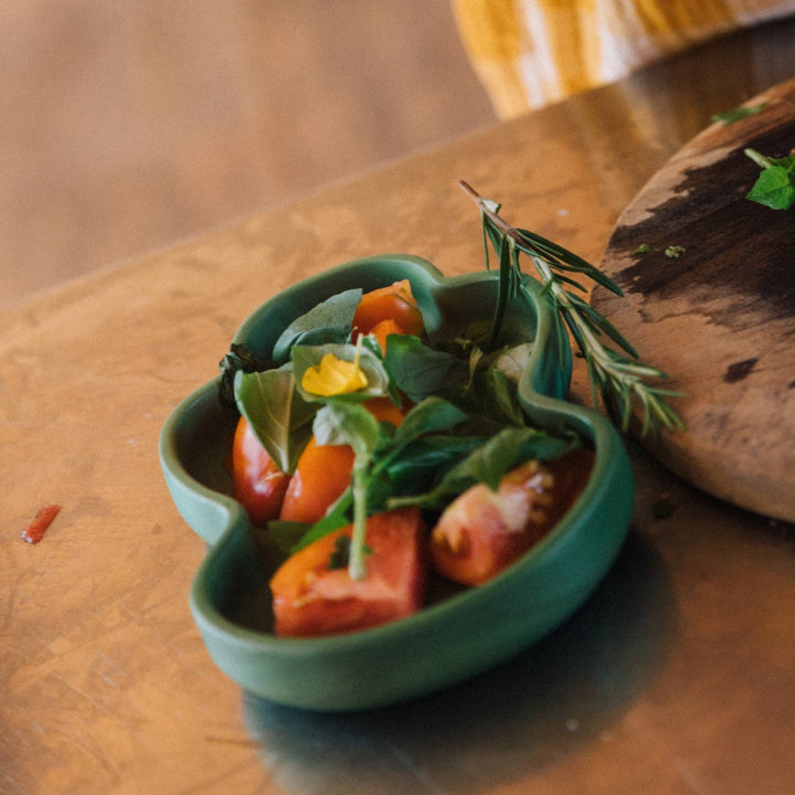 Colorful produce served on the Kendall the Kale plate resting on a rustic wooden table