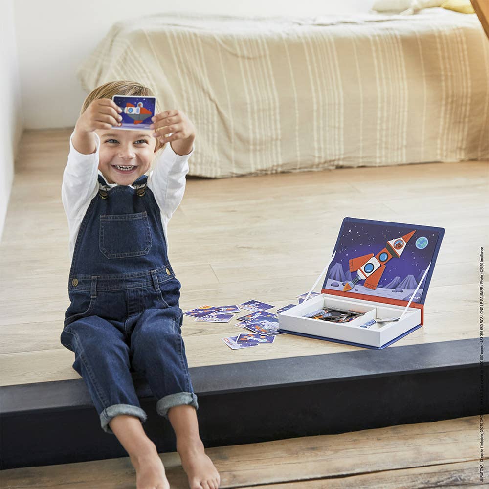 Kids magnet toys in action: child playing with a rocket ship from Janod's Magneti'book Cosmos