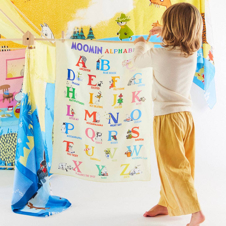 Sarah's Silks Moomin Alphabet Playsilk doubles as a canopy in this cozy play tent