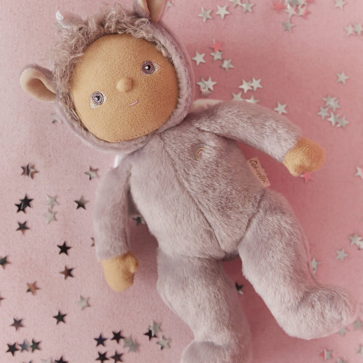 Dinkum Dolls Uma Unicorn palm-sized doll lying on a pink blanket with star confetti