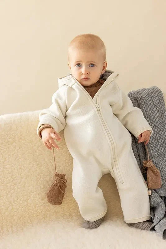 Baby in a cream hooded wool suit with Caramel Disana Organic Merino Wool Baby Mittens, organic winter clothes for infants