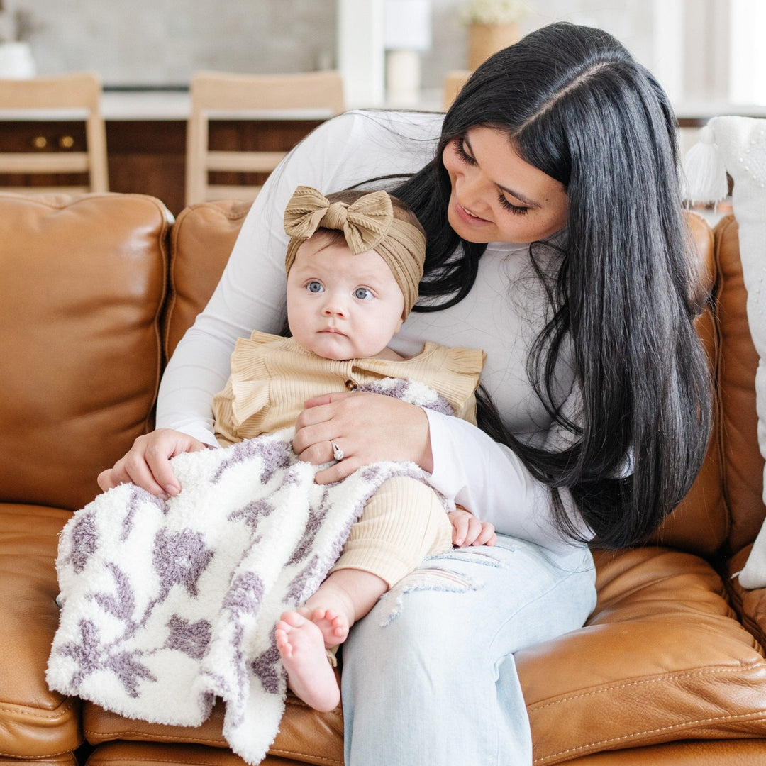 Soft, serene, and stylish Ñ the Saranoni Double-Layer BAMBONI¨ Mini Blanket in Pansy defines what a soft baby blanket should be.