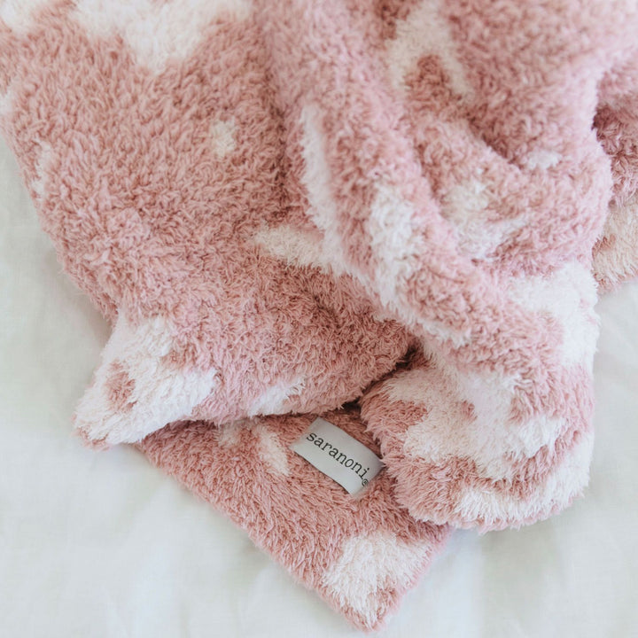SaranoniÕs Petal Double-Layer BAMBONI¨ Mini Blanket delivers unmatched warmth and comfort, a standout among soft baby blankets.