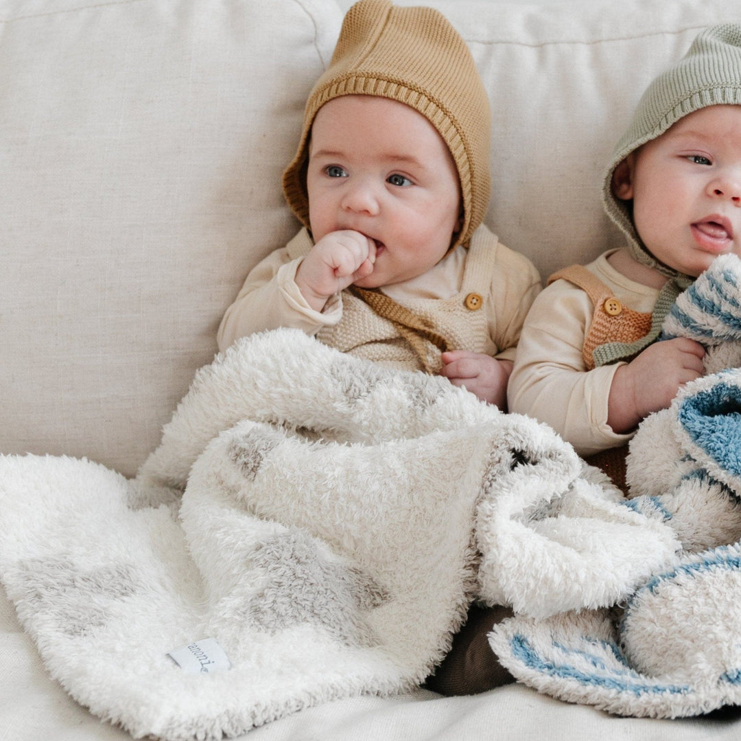 Wrap your baby in serene comfort with the Saranoni Double-Layer BAMBONI¨ Mini Blanket in Swiss Cross, the coziest baby blanket for snuggle time.