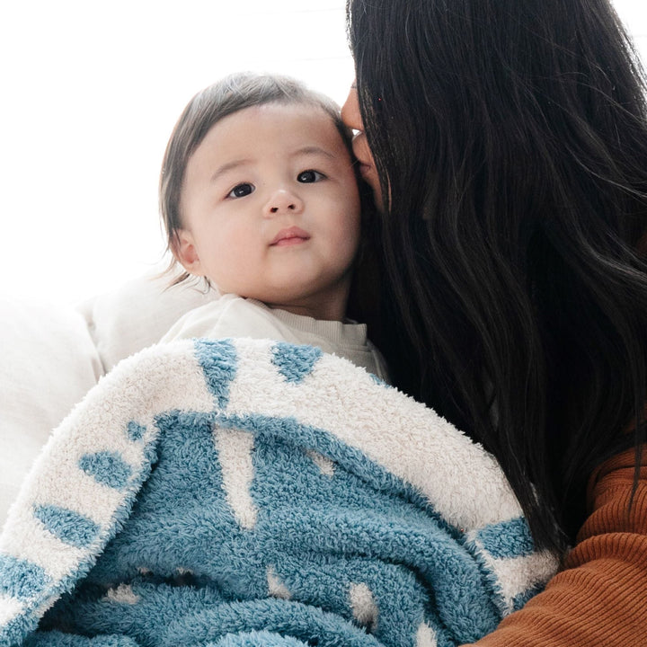 Soft as a dream, the Triangle Saranoni Double-Layer BAMBONI¨ Mini Blanket is adored for its texture, ranking high among the best baby blankets.
