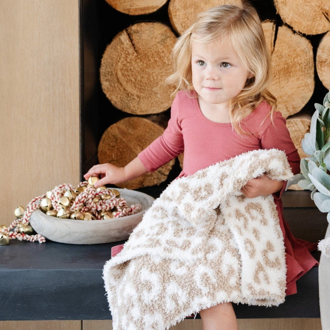 SaranoniÕs Double-Layer BAMBONI¨ Mini Blanket in Tan Leopard brings subtle sophistication and comfort, the best toddler blanket for cozy moments.