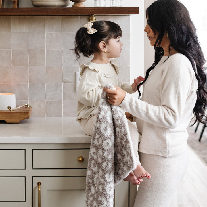 The Saranoni Double-Layer BAMBONI¨ Mini Blanket in Gray Leopard surrounds your little one in cozy warmth Ñ the perfect soft baby blanket.