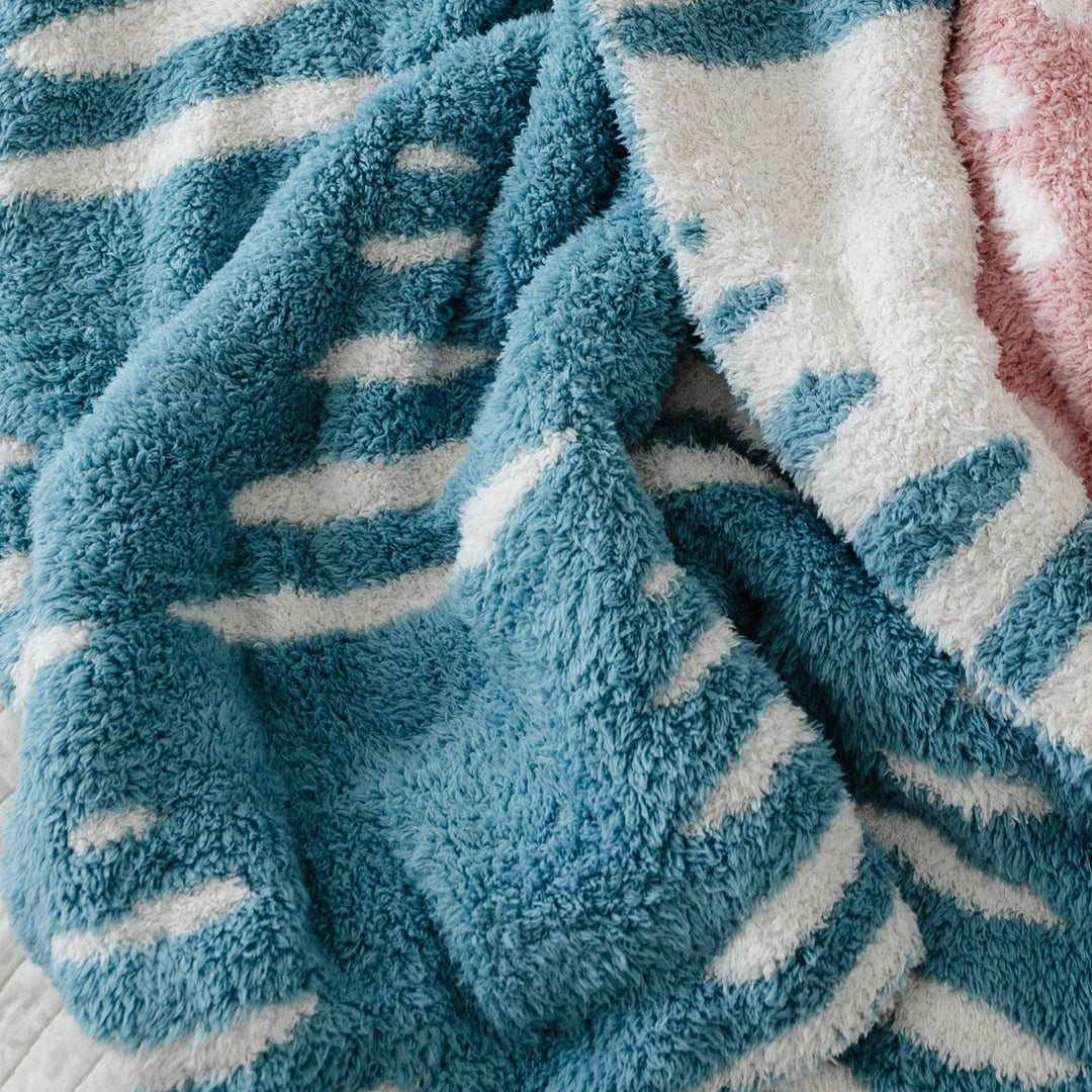 Keep your baby snug with the Saranoni BAMBONI¨ Receiving Blanket, Triangle pattern, a premium soft baby blanket.