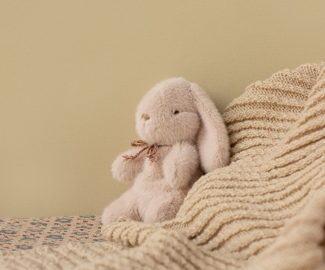Captured in a cozy moment, the Maileg Plush Bunny Mini in Light Powder stands out as an adorable stuffed animal.