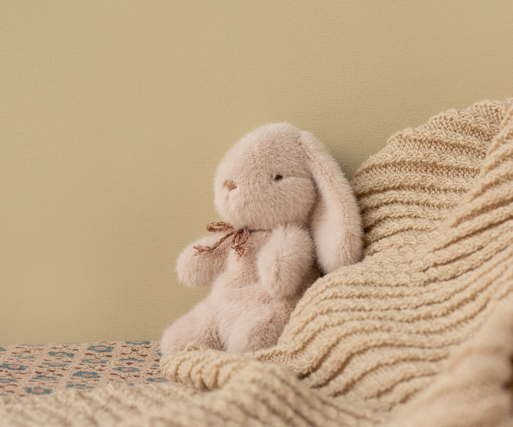 Captured in a cozy moment, the Maileg Plush Bunny Mini in Light Powder stands out as an adorable stuffed animal.