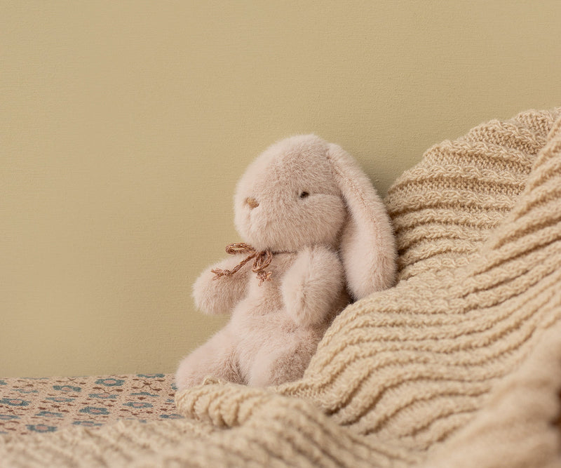 Captured in a cozy moment, the Maileg Plush Bunny Mini in Light Powder stands out as an adorable stuffed animal.