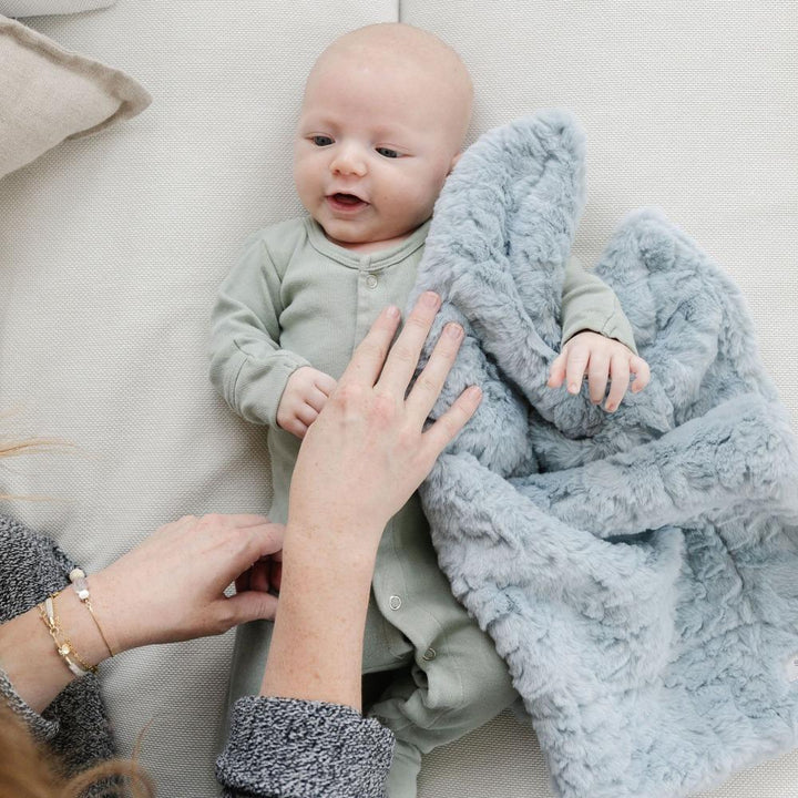 The Saranoni Dream Mini Blanket in Heather Blue combines classic design and plush feel, ideal for baby girl blankets.