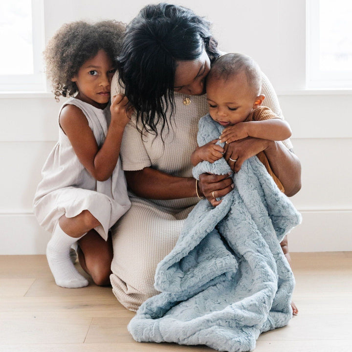 Crafted for comfort, the Saranoni Dream Receiving Blanket in Heather Blue keeps your little one cozy as a classic infant receiving blanket.