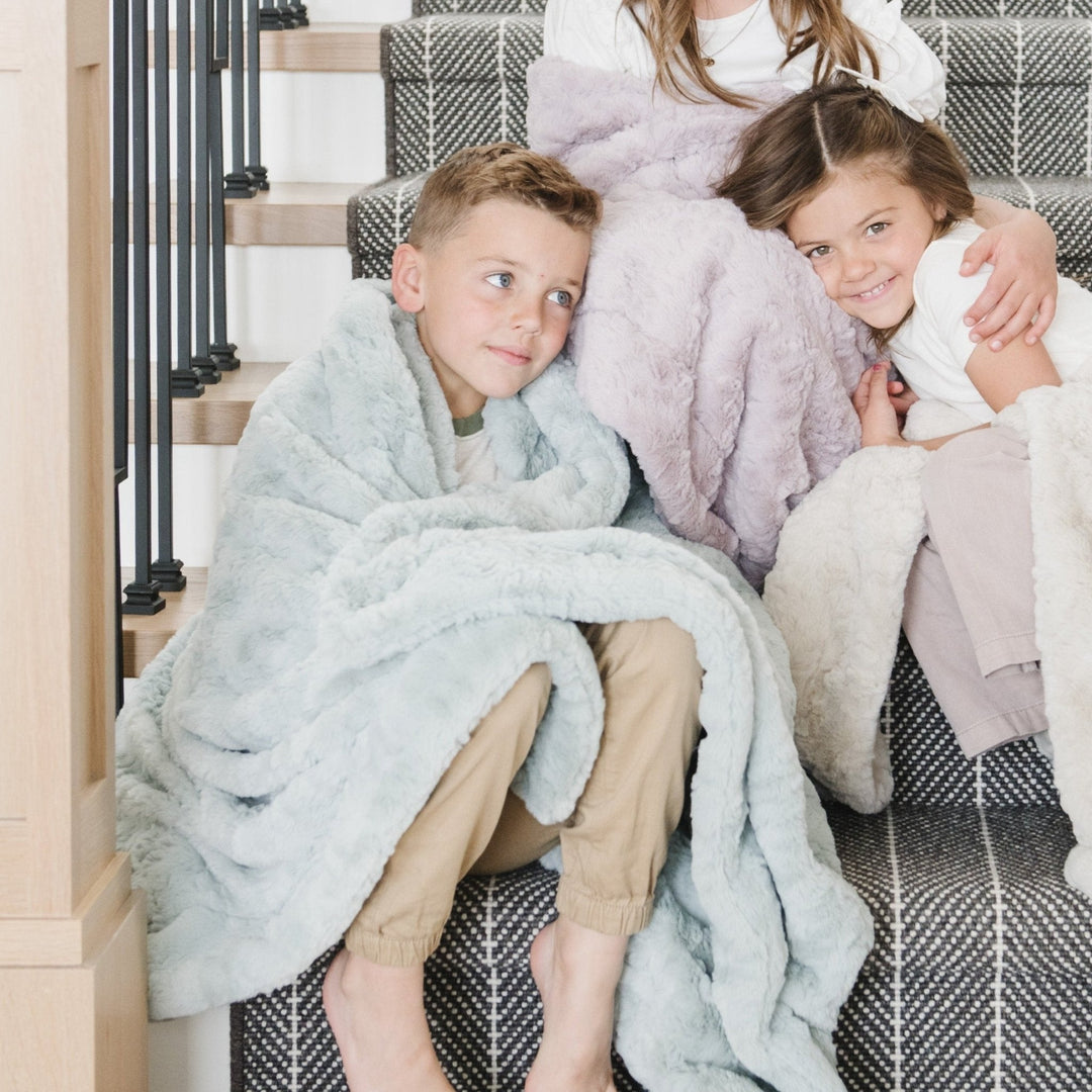 Wrap your little one in the Saranoni Dream Toddler Blanket, shown in various colors, the ultimate soft baby blanket for all seasons.