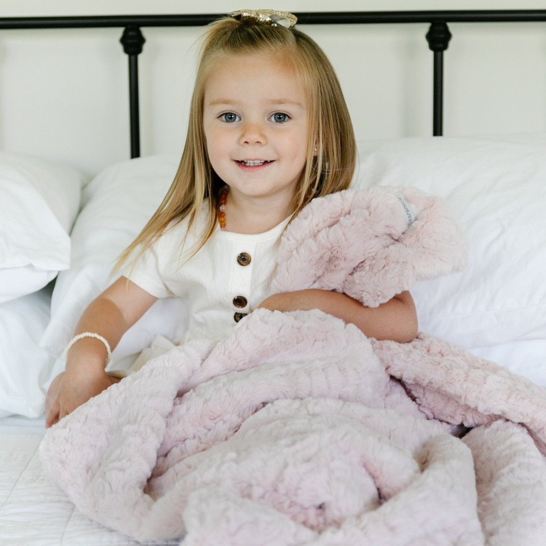 In Blush, the Saranoni Dream Toddler Blanket surrounds your toddler in luxurious softness, the best baby blanket upgrade.