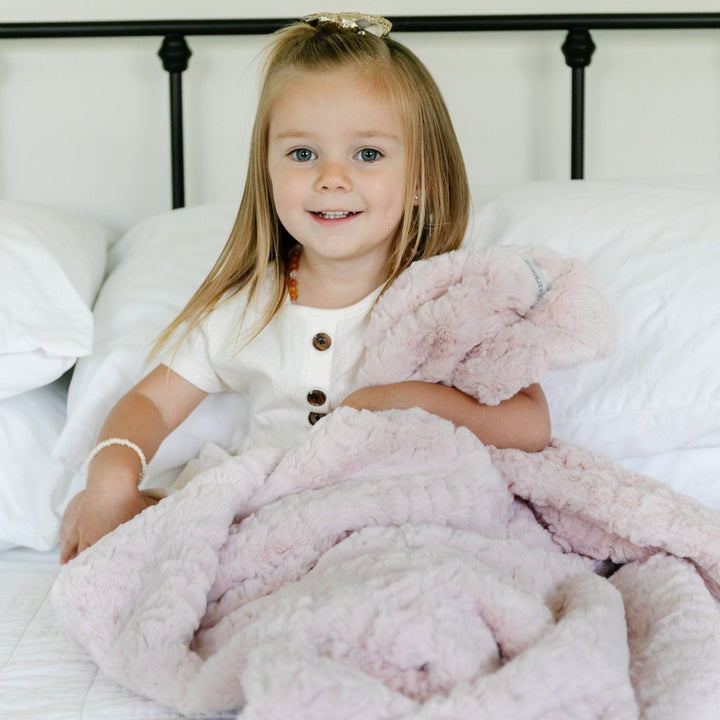In Blush, the Saranoni Dream Toddler Blanket surrounds your toddler in luxurious softness, the best baby blanket upgrade.