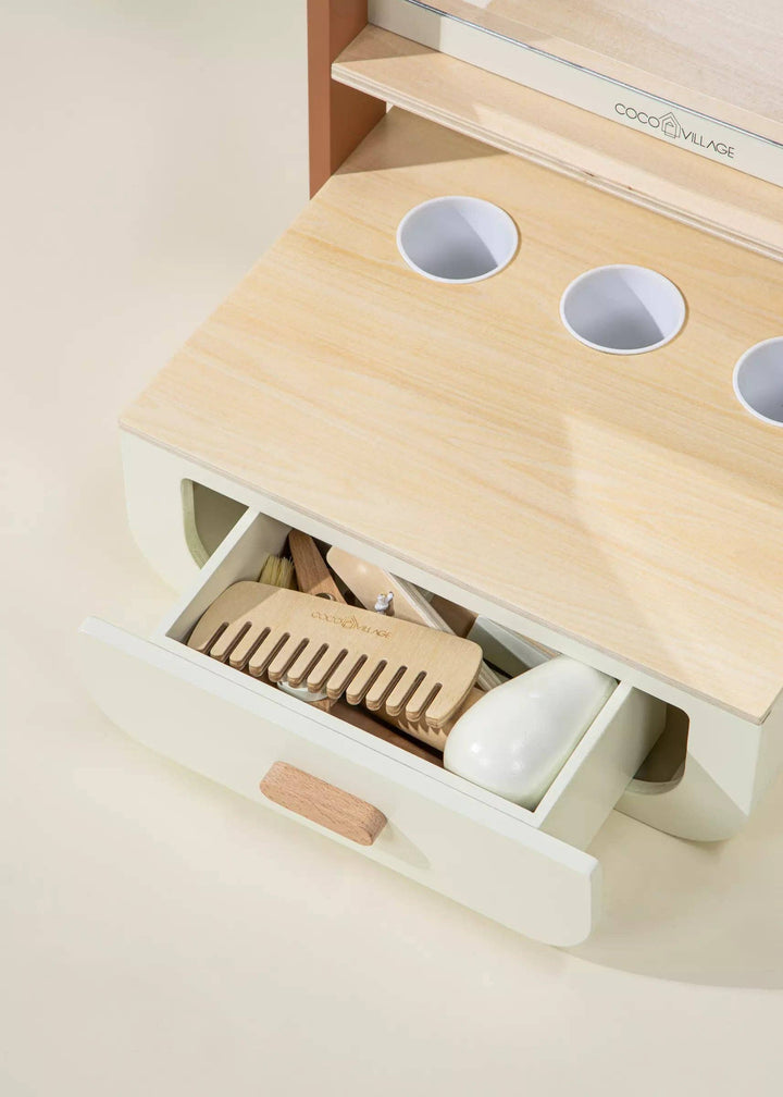 Create imaginative moments with the Coco Village Wooden Beauty Station Playset in Peach, a creative developmental toy for hands-on fun.