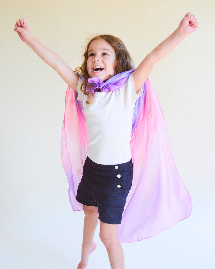 Child wearing rainbow Enchanted Playsilks as cape
