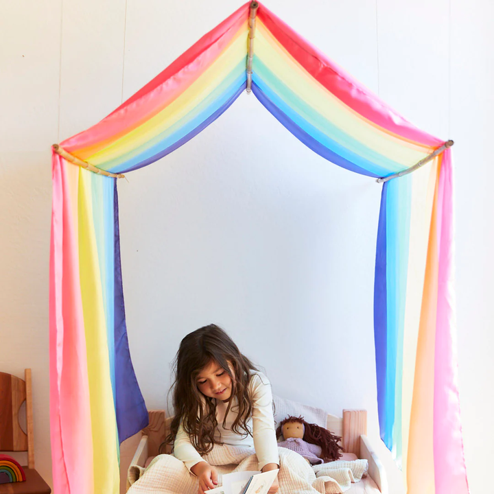 Sarah's Silks Double Rainbow Playsilk drapes into a dreamy bed canopy for quiet reading time