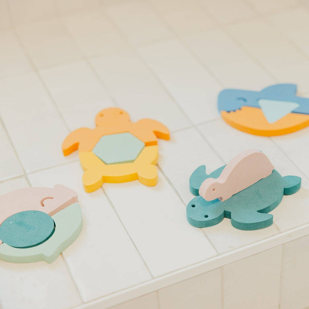 Copper Pearl foam bath toys arranged on tub, toddler bath toys for interactive water play