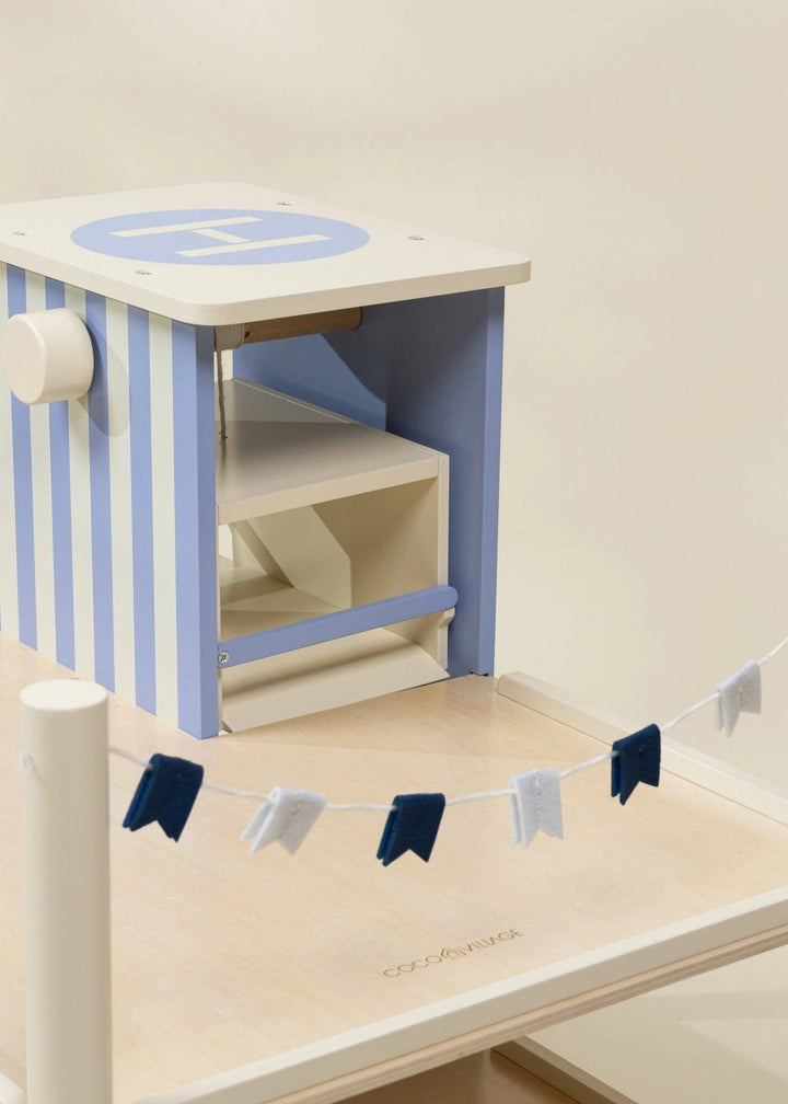 Rooftop helipad detail on the Wooden Parking Garage Playset, a Coco Village pretend play toy