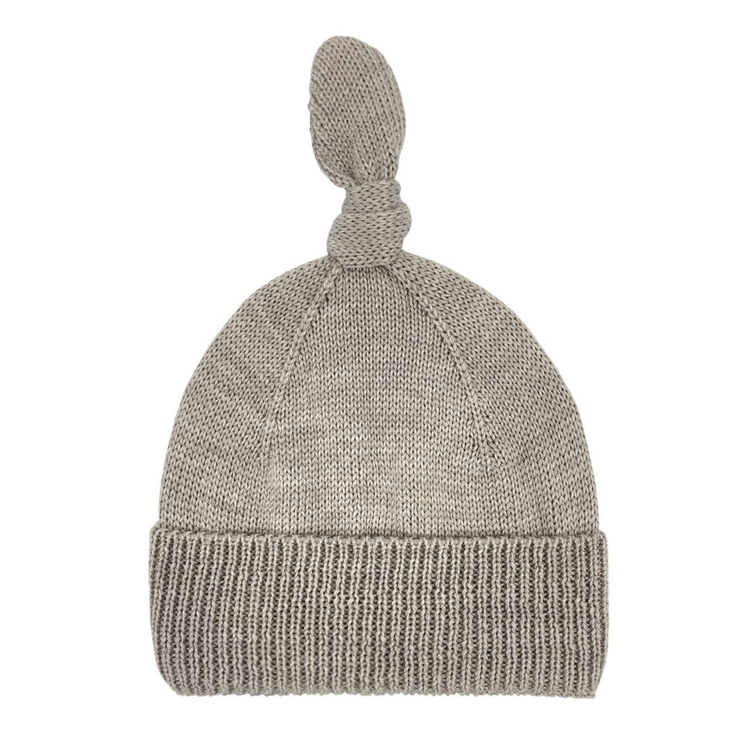 Beige knitted baby hat with a knotted top and ribbed cuff, ALIAP Merino Wool Top Knot Baby Beanie for 3 to 12 months