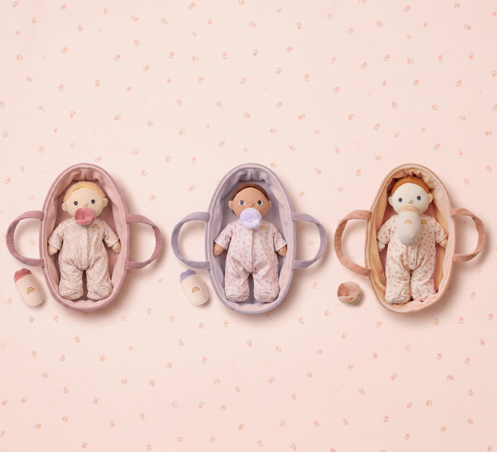 Three Binky Dinky baby dolls in pink, lavender and peach bassinets from Dinkum Dolls