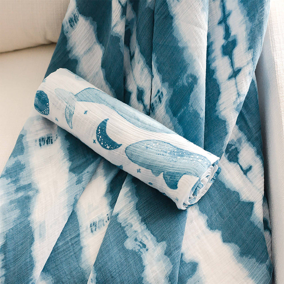 close up of rolled up crane baby caspian blue swaddle set 