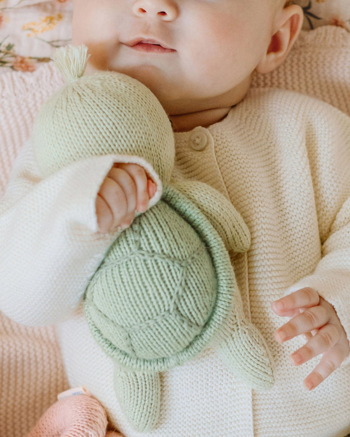 Bathed in warm natural light, Cuddle + Kind Baby Sea Turtle stuffies showcase thoughtful craftsmanship