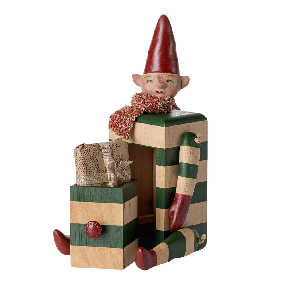A charming Maileg Elf with Drawer posed with colorful accessories, ideal for any Maileg mini doll house.