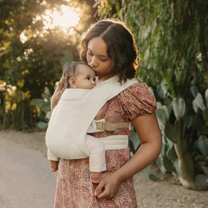 Cream offers clean simplicity in the Ergobaby Embrace Newborn Carrier, a beloved newborn baby carrier.
