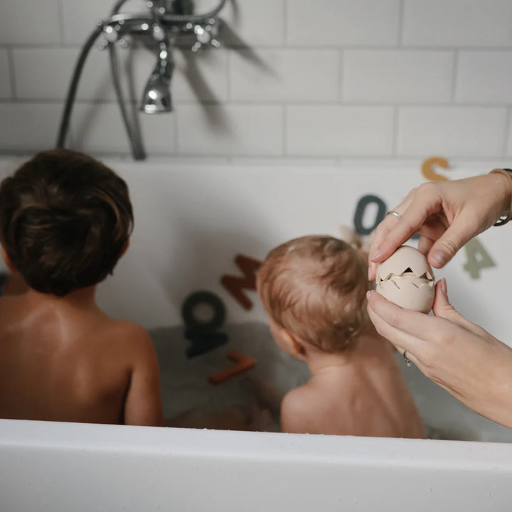 two children playing with mushie mold free silicone bath toy play set 