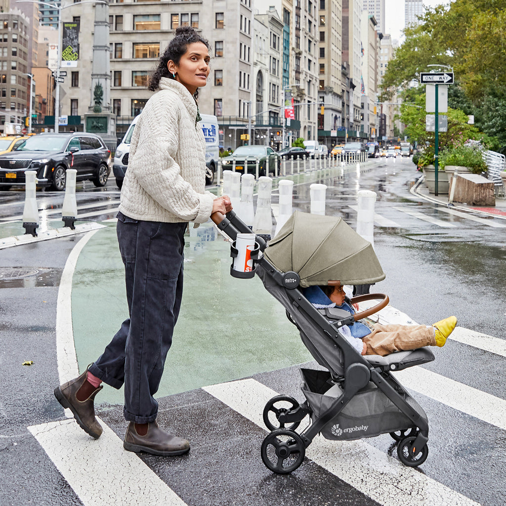 Mom pushing Metro Plus Stroller outdoors