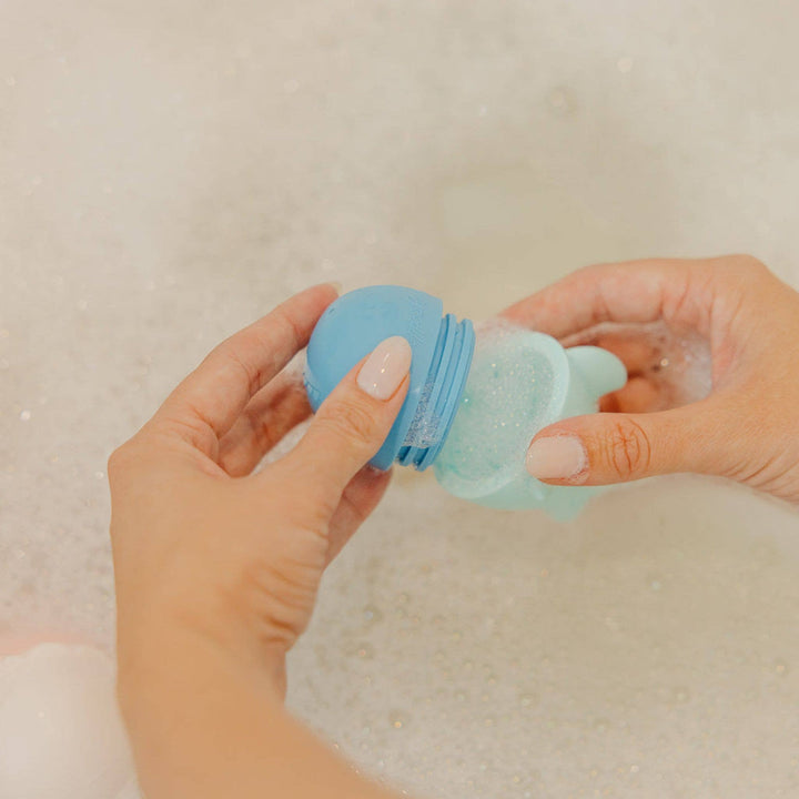 Squirtie bath toys on wall and tub, toddler bath toys for interactive water play and bath time fun