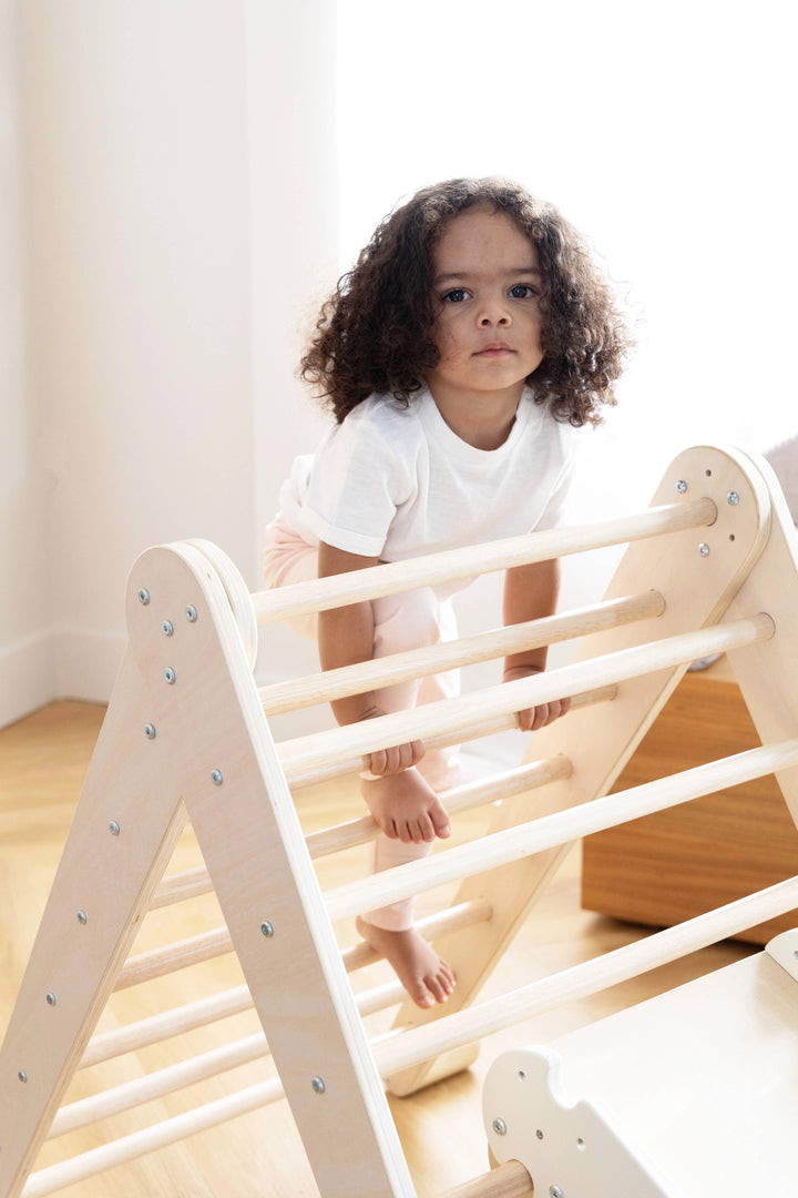 Capture movement with the Coco Village Montessori 2-in-1 Triangle & Wall Climber in Natural wood, a standout Montessori toy for active learning.