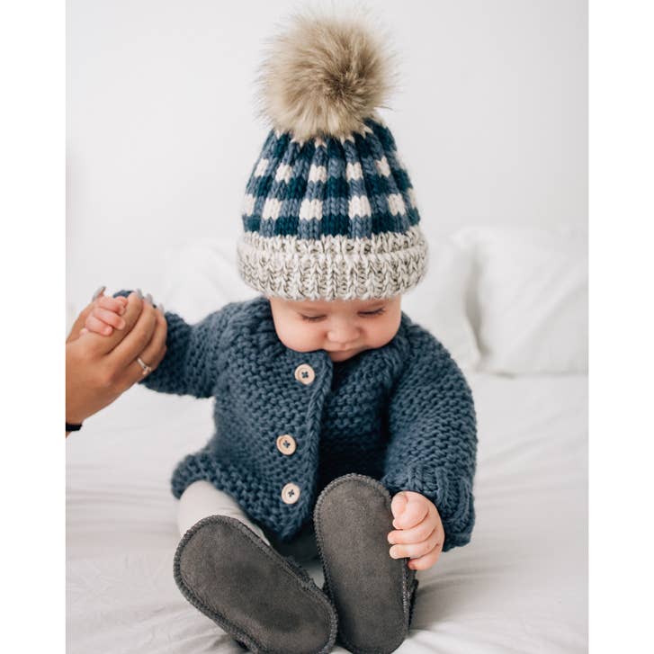 Toddler wearing Huggalugs Slate cardigan sweater, cozy cable knit raglan sleeves