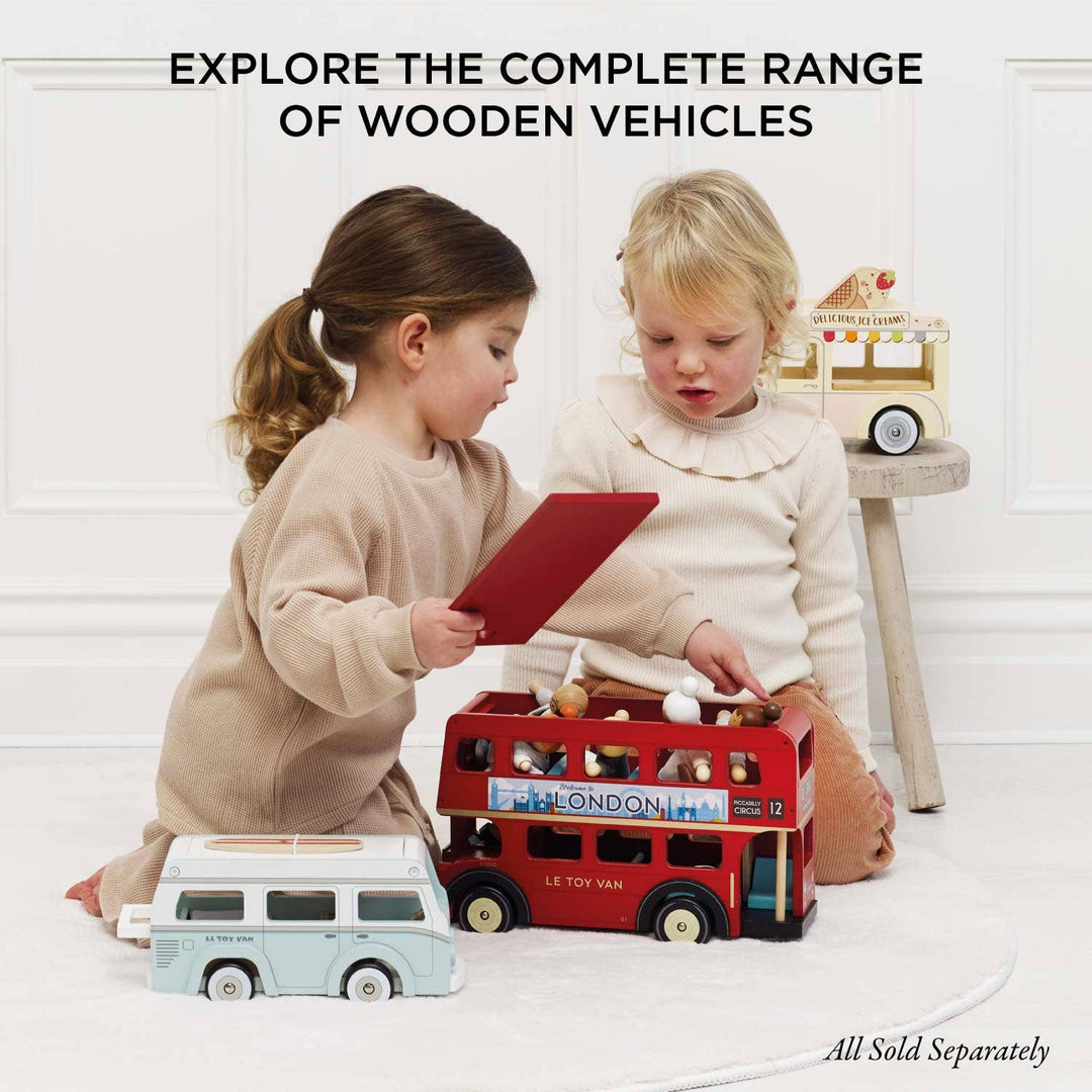 Two children playing with a red bus and blue van from the Le Toy Van wooden vehicles range, Mobile Café Van companions