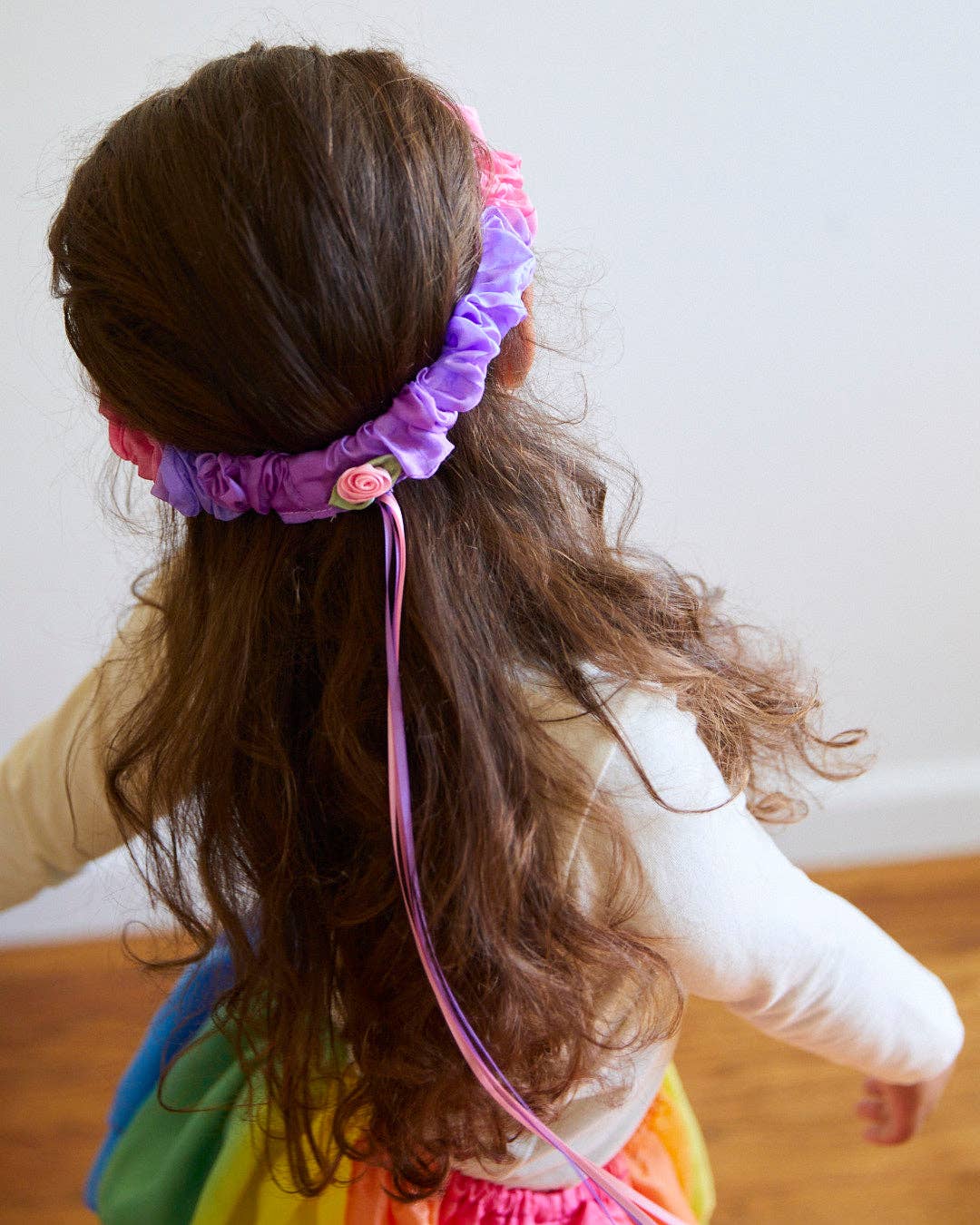 Back view of the Sarah's Silks Blossom Garland, styled with flowing hair and ribbon ties
