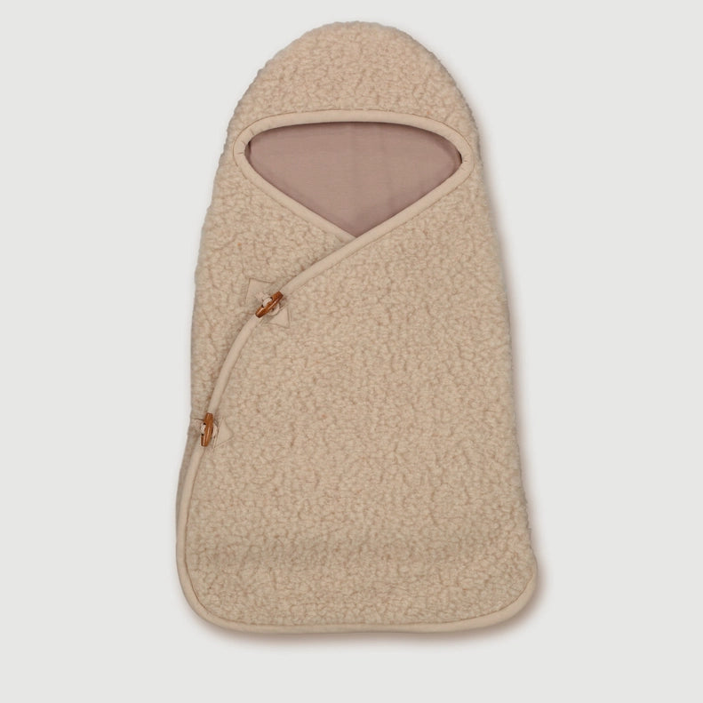 Wrap your newborn in the Finch & Fable Wool Cocoon in OatÑan ultra-gentle newborn sleep sack designed for warmth and comfort.