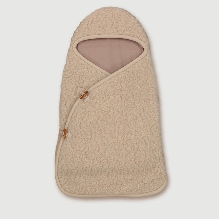 Wrap your newborn in the Finch & Fable Wool Cocoon in OatÑan ultra-gentle newborn sleep sack designed for warmth and comfort.